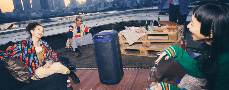 people listening to the Xseries Bluetooth Portable Party Speaker outside 