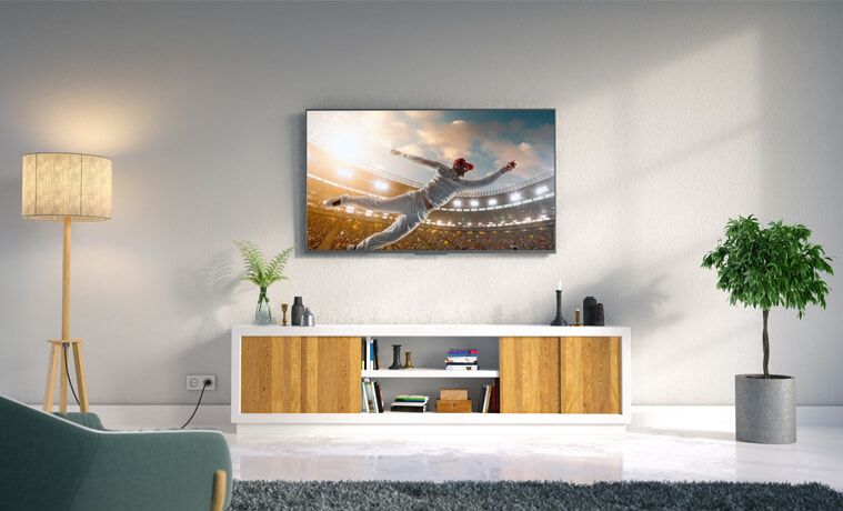 A cricketer catches a ball on the screen of a 4k TV