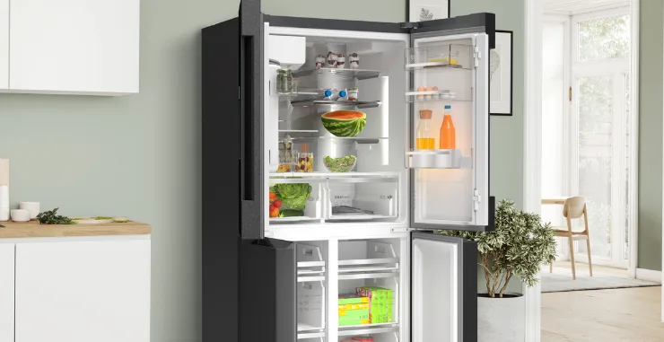 Open french door Bosch refridgerator in kitchen.