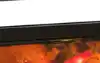 Tefal Infra Heat air fryer with a viewing window showing food cooking inside, next to a plate of glazed salmon and a baked dish on a marble bench.
