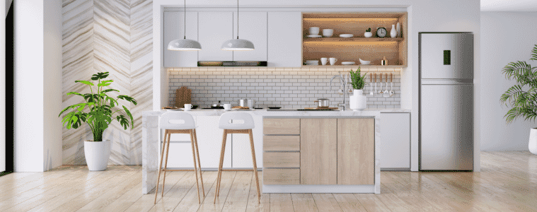 Lifestyle image of a modern kitchen with a top mount silver refrigerator.