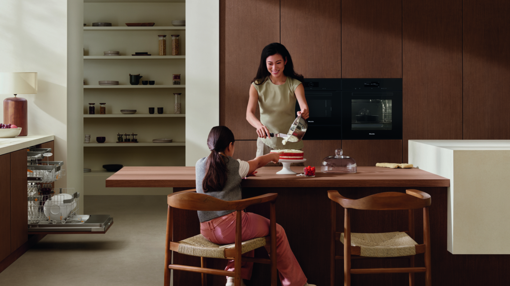 Lifestyle image of mother cooking in a miele kitchen