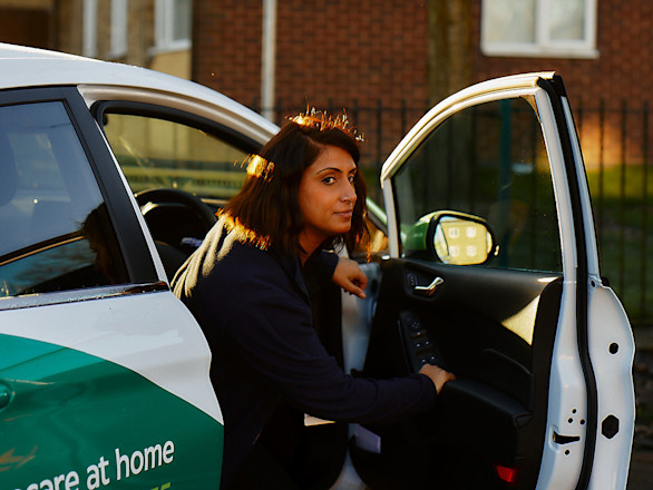A Specsavers domiciliary optician gets out of a car