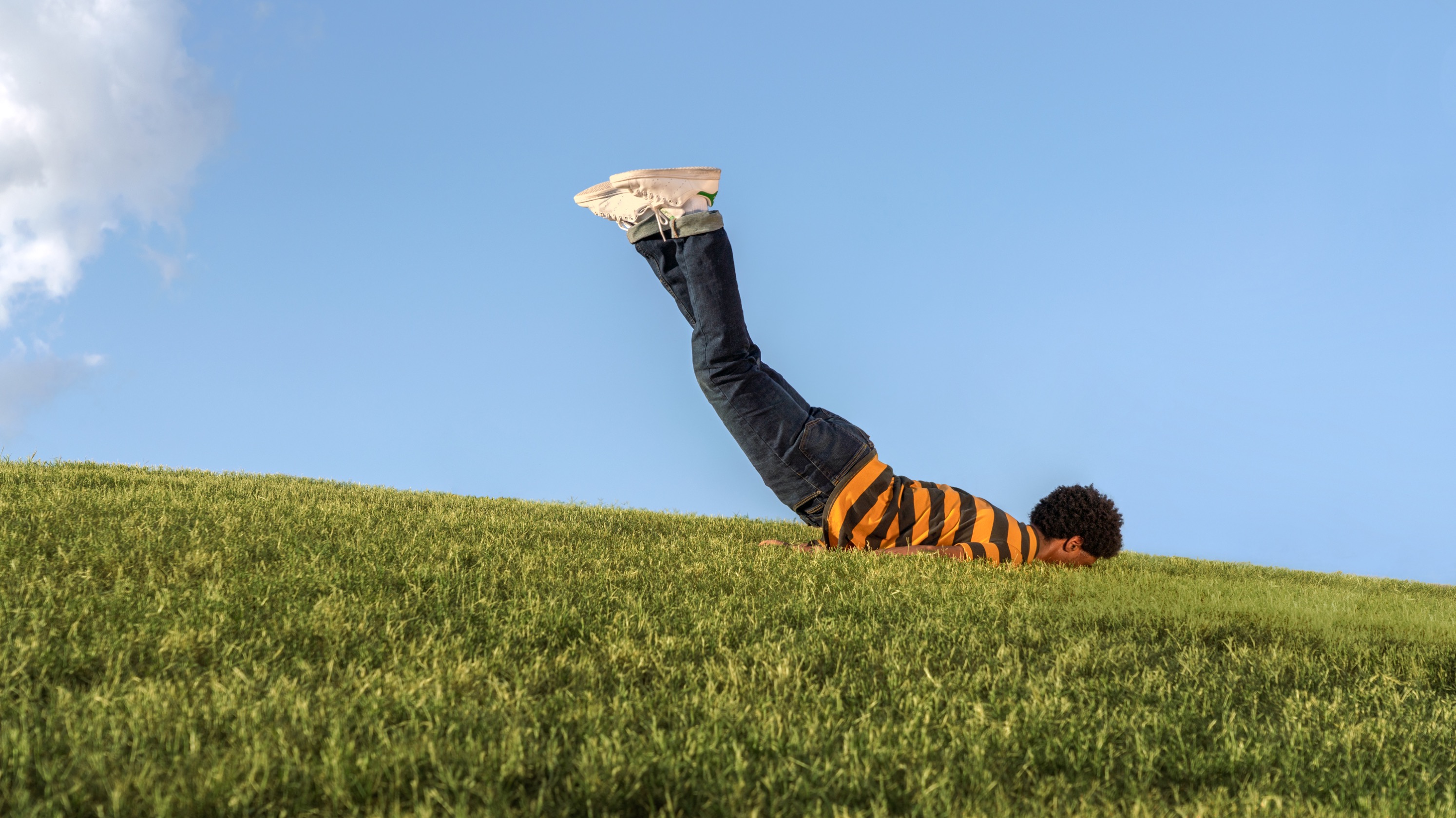 man-facedown-on-a-grassy-field-in-springtime