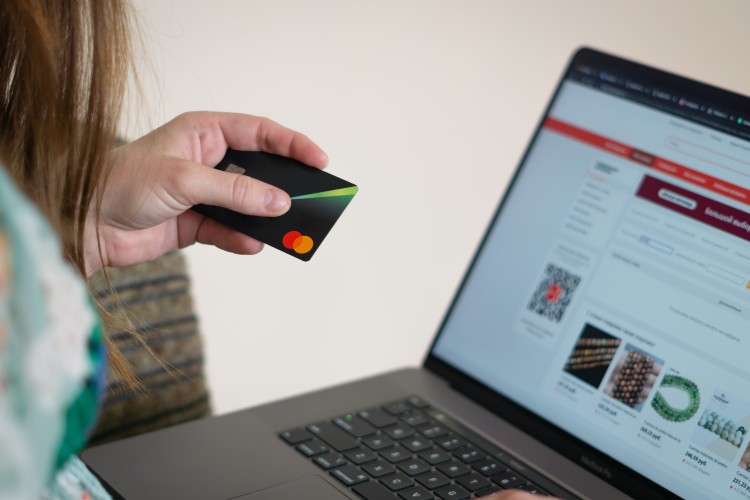 Person online shopping with a debit card