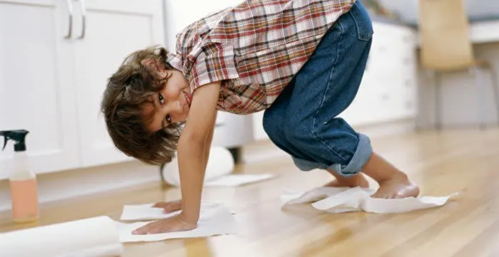 Kid on all fours with a Bounty sheet under each of his hands and feet