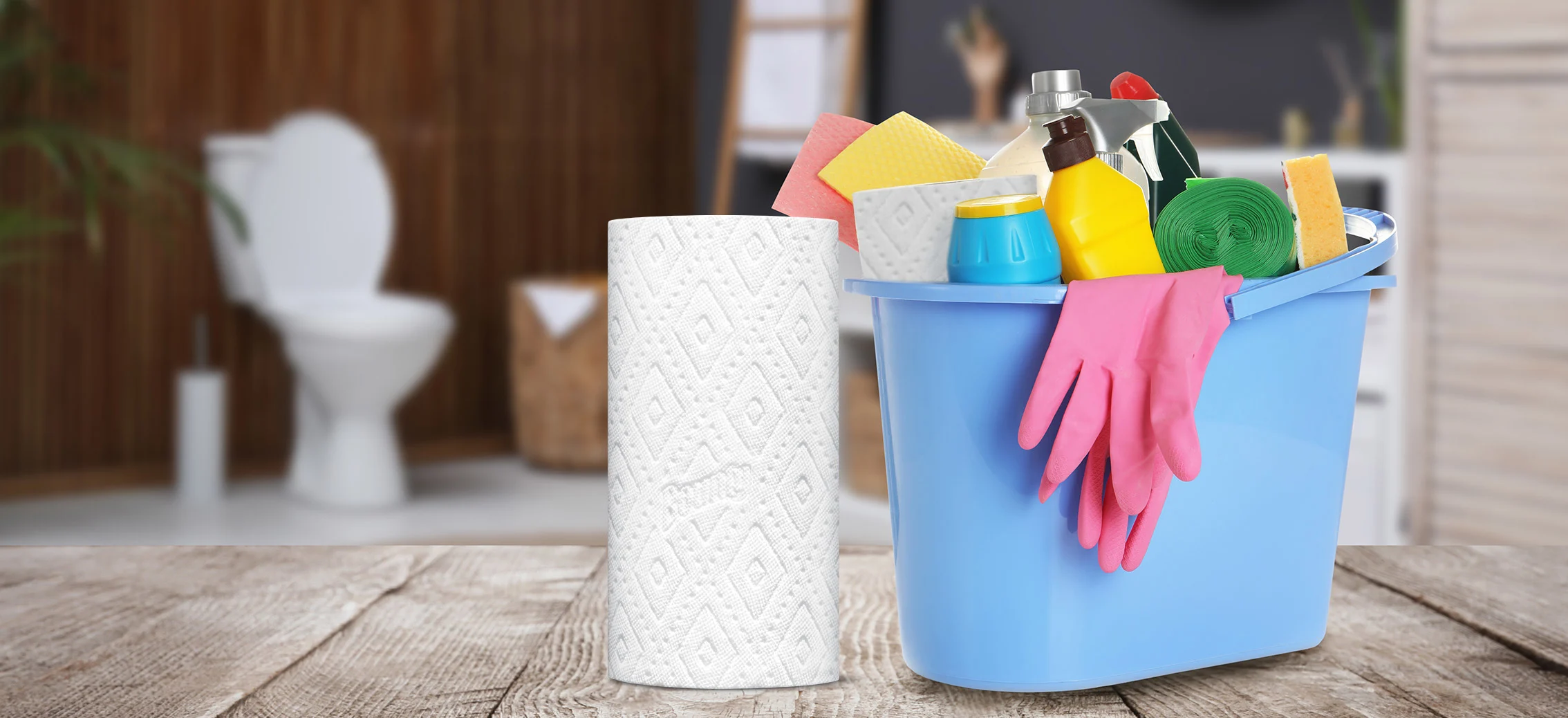 A blue bucket filled with cleaning supplies next to a Bounty paper towel roll 