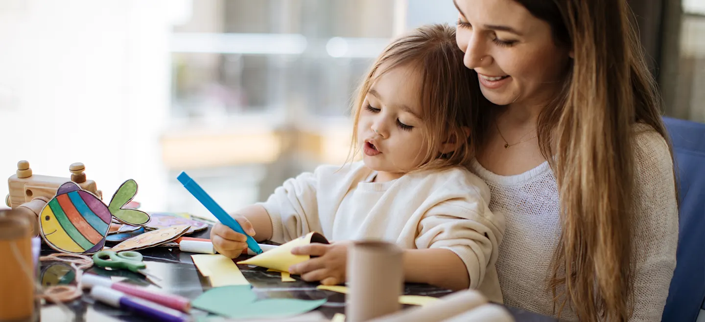 Woman doing arts and crafts with her daughter