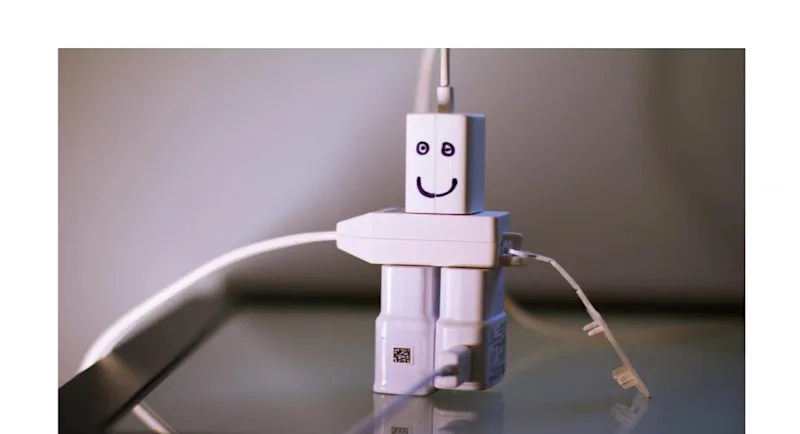 USB phone cables arranged to look like a small robot.