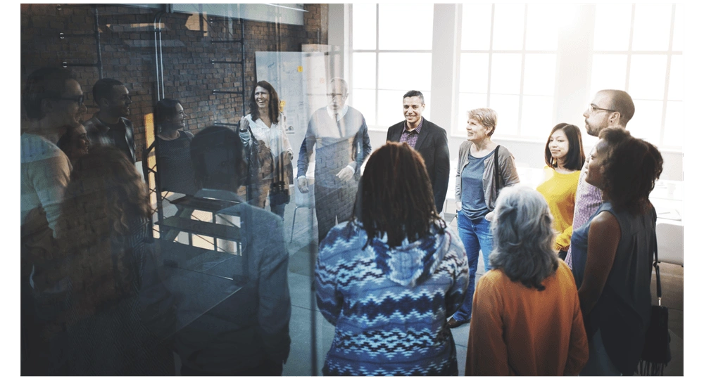 A team in a work office doing morning Scrum standup.