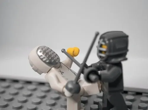 Two lego men sword fighting.