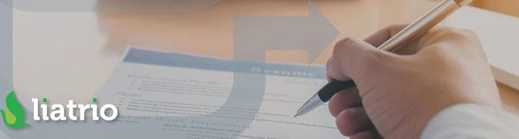 A man's hand holding a pen and signing a form.