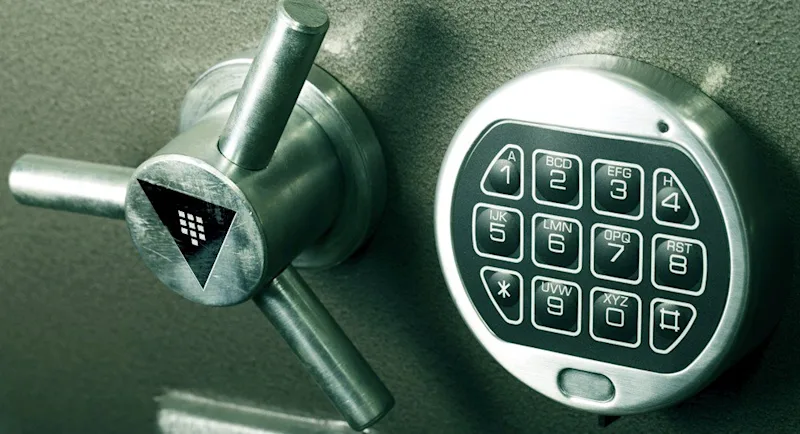 A safe combination lock with the Vault logo overlaid on top.