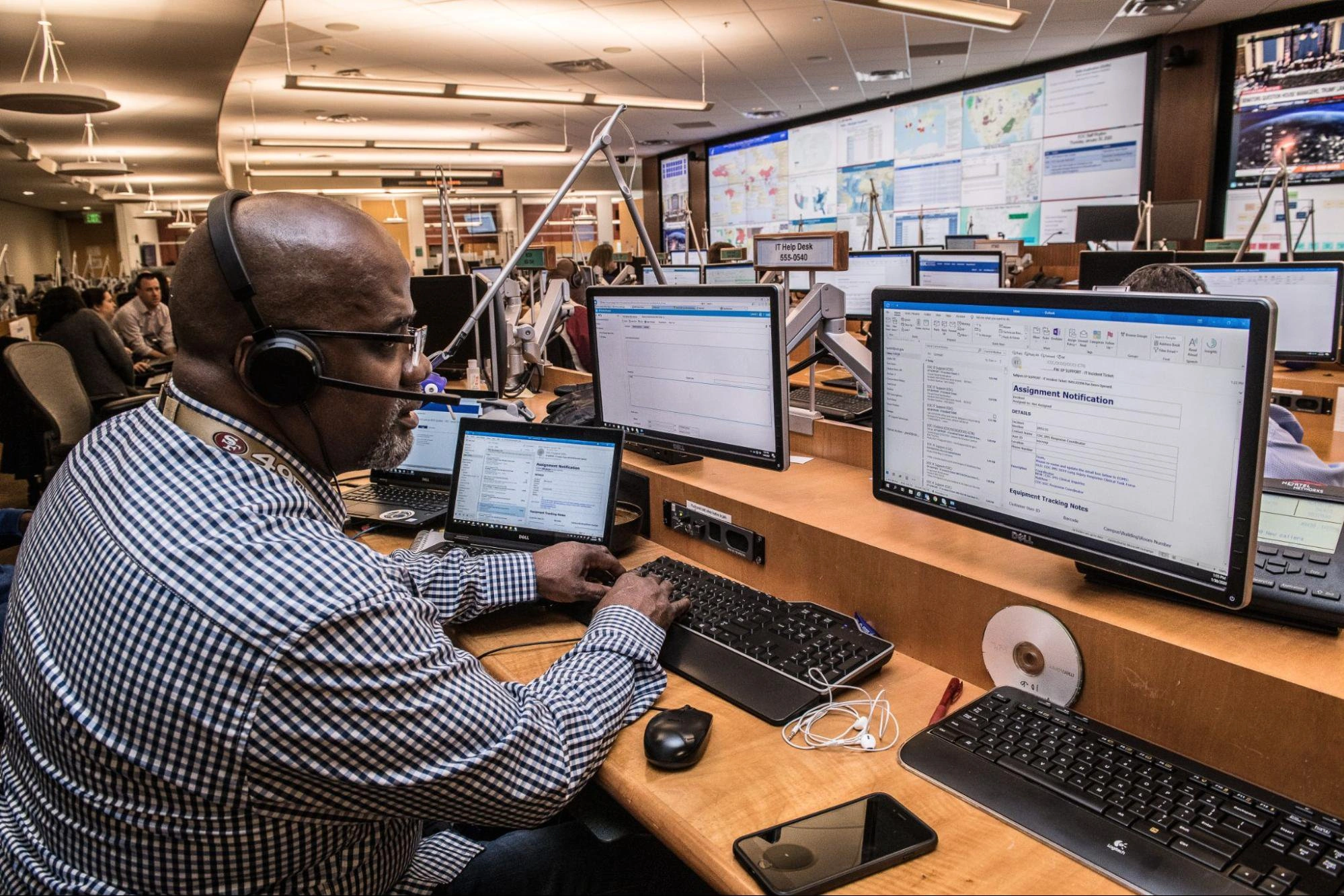 A man sitting at a desk working on a computer.