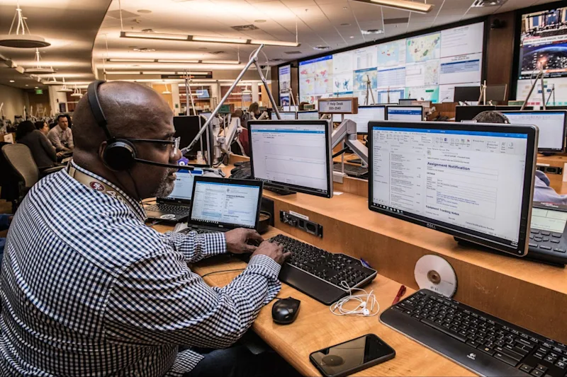 A man sitting at a desk working on a computer.
