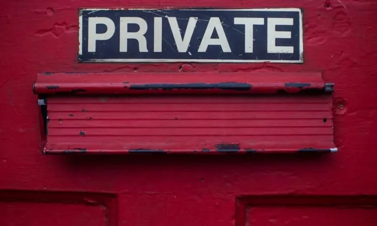 A closeup of a red door with the label 'Private'.