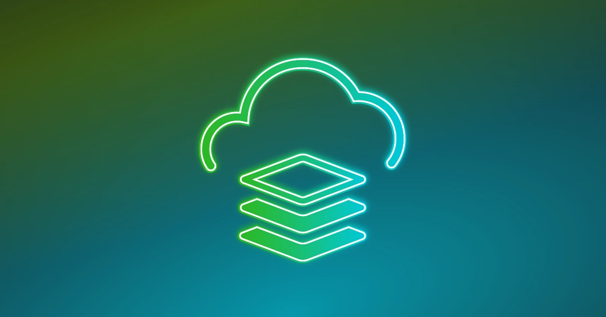 A top down view of a laptop, a mobile phone, and a plant sitting on a desk.