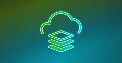 A top down view of a laptop, a mobile phone, and a plant sitting on a desk.