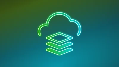 A top down view of a laptop, a mobile phone, and a plant sitting on a desk.