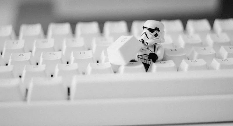A Lego stormtrooper inside of a computer keyboard