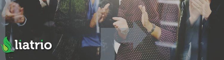 A group of people standing around each other clapping.