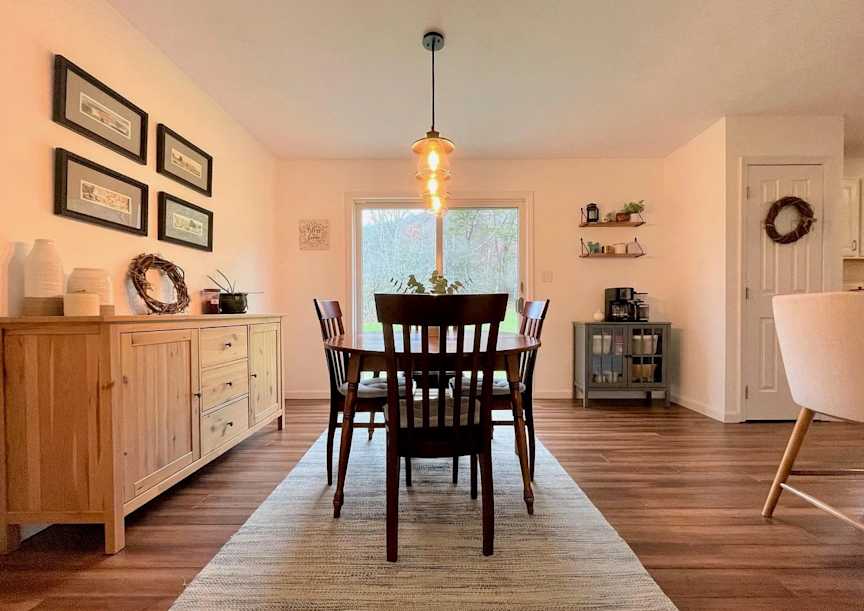 Wiltshire - Dining Room - After, The hardwood flooring and off-white walls continue into the dining room and kitchen, creating a more cohesive connection between the rooms and making the entire space feel larger.
