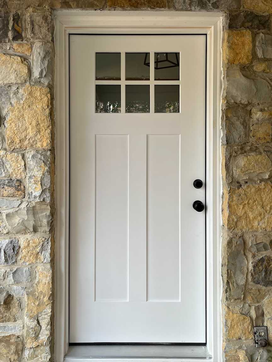 Barkway House - Foyer - New Front Door, A new craftsman style front door provided a weather-tight seal, eliminating cold winter drafts while improving comfort on the main floor and overall energy efficiency.