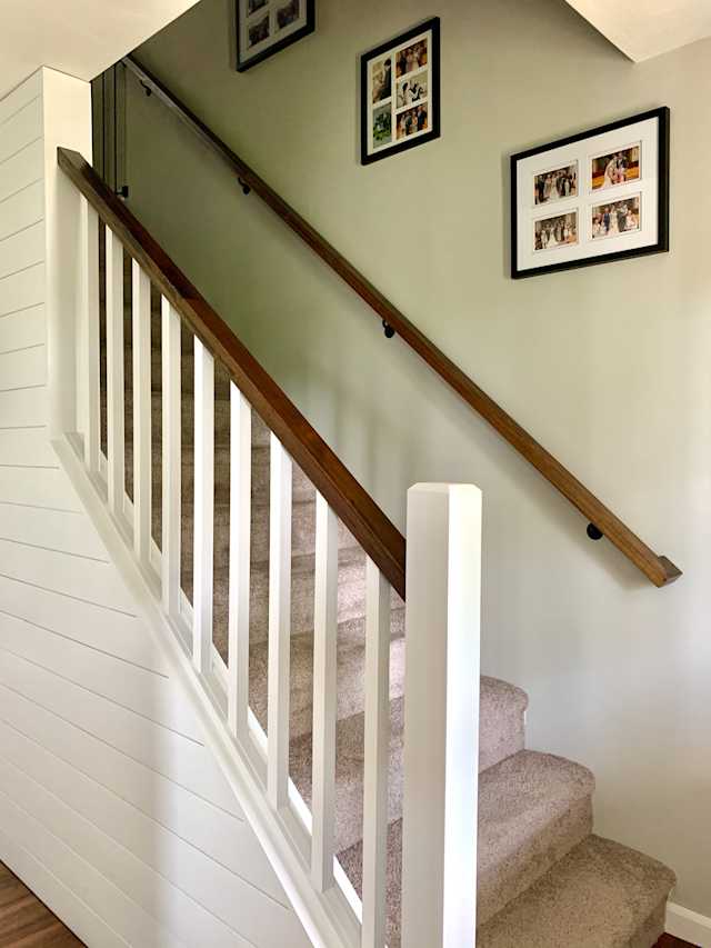 Wiltshire - Foyer - After, A simple white stair banister introduces a contemporary feel at the entry, while dark oak handrails tie into the new hardwood floors. Shiplap siding along the stairwell wall creates a focal point from an otherwise overlooked hallway.