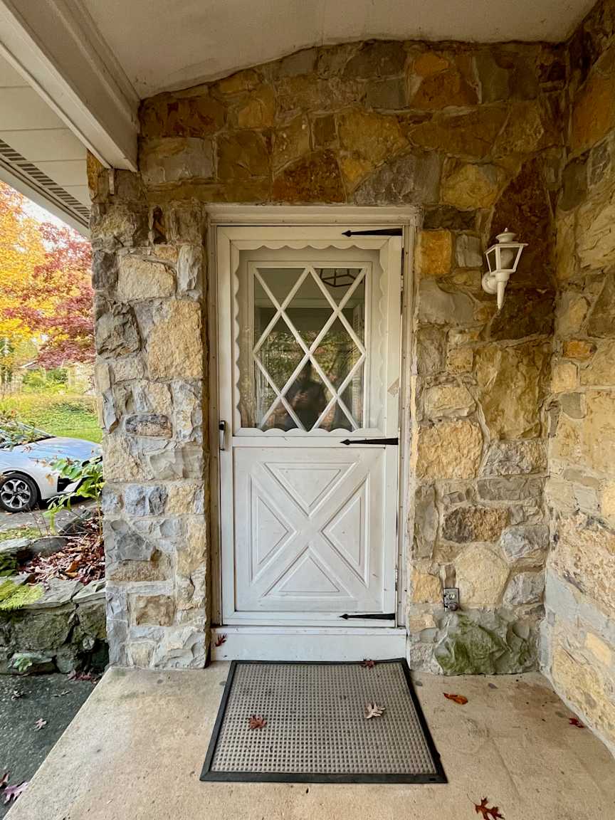 Barkway House - Foyer - Front Door Before, BEFORE: The original front door lacked weather stripping because of the height of the existing flooring, allowing cold air into the foyer and making the main floor uncomfortably cold in winter.