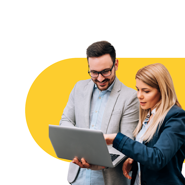 A man in glasses is delighted to show a blonde woman something on his laptop.