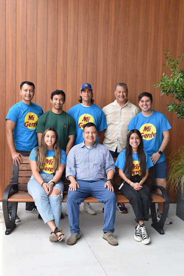 Members of nCino's Mi Gente pose on a bench outside nCino's headquarters.