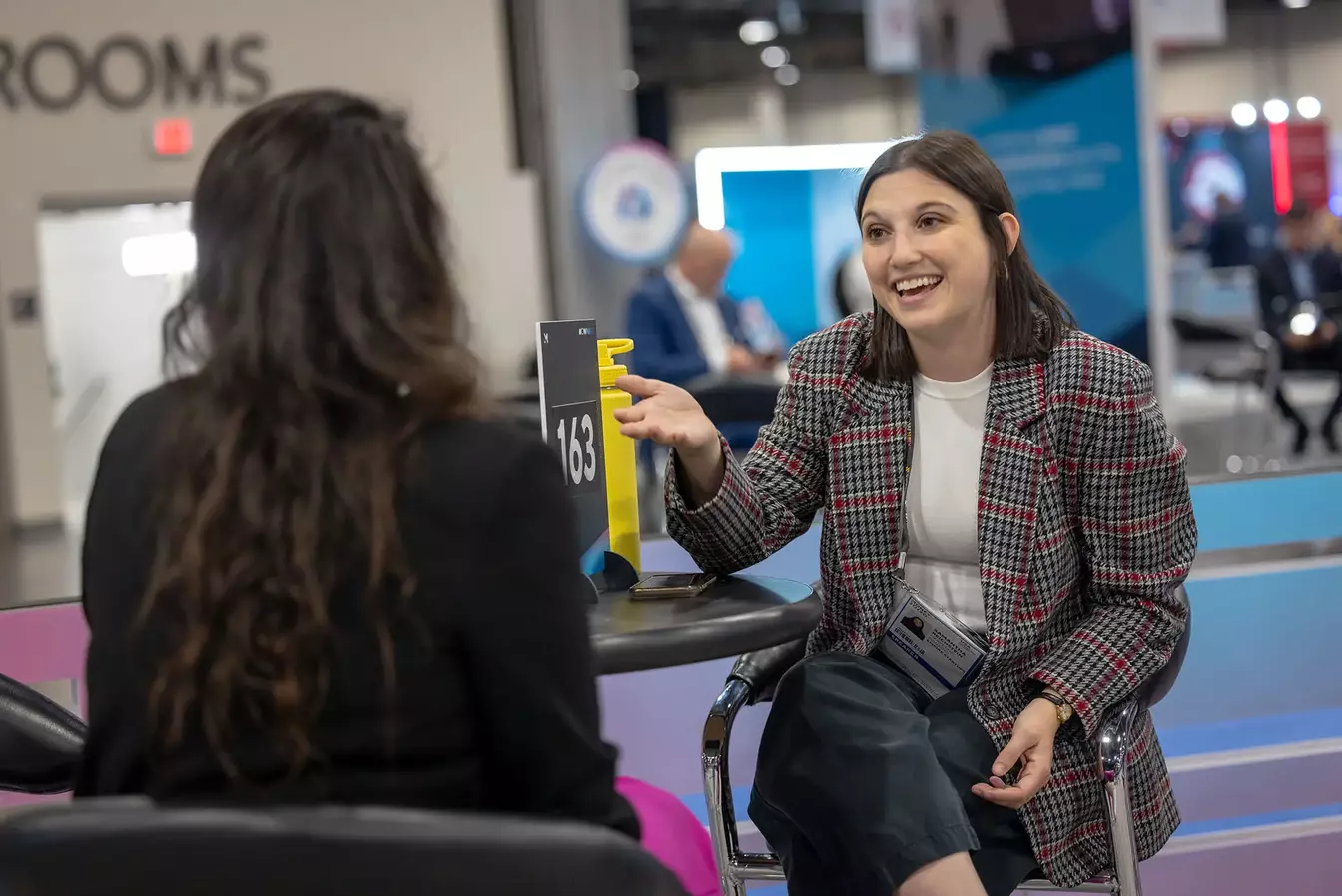 Two women networking at Money20/20.