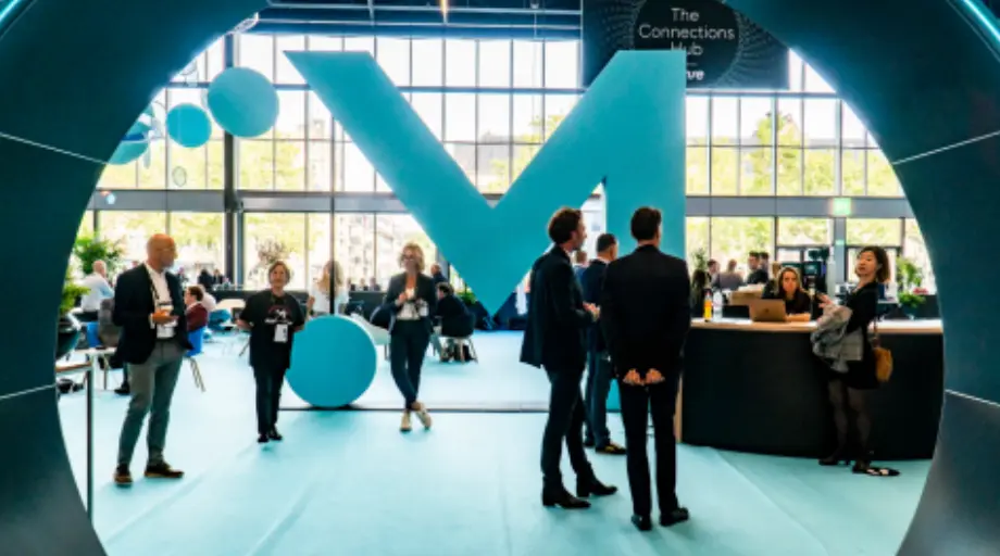 Two men and a woman take a selfie at Money20/20