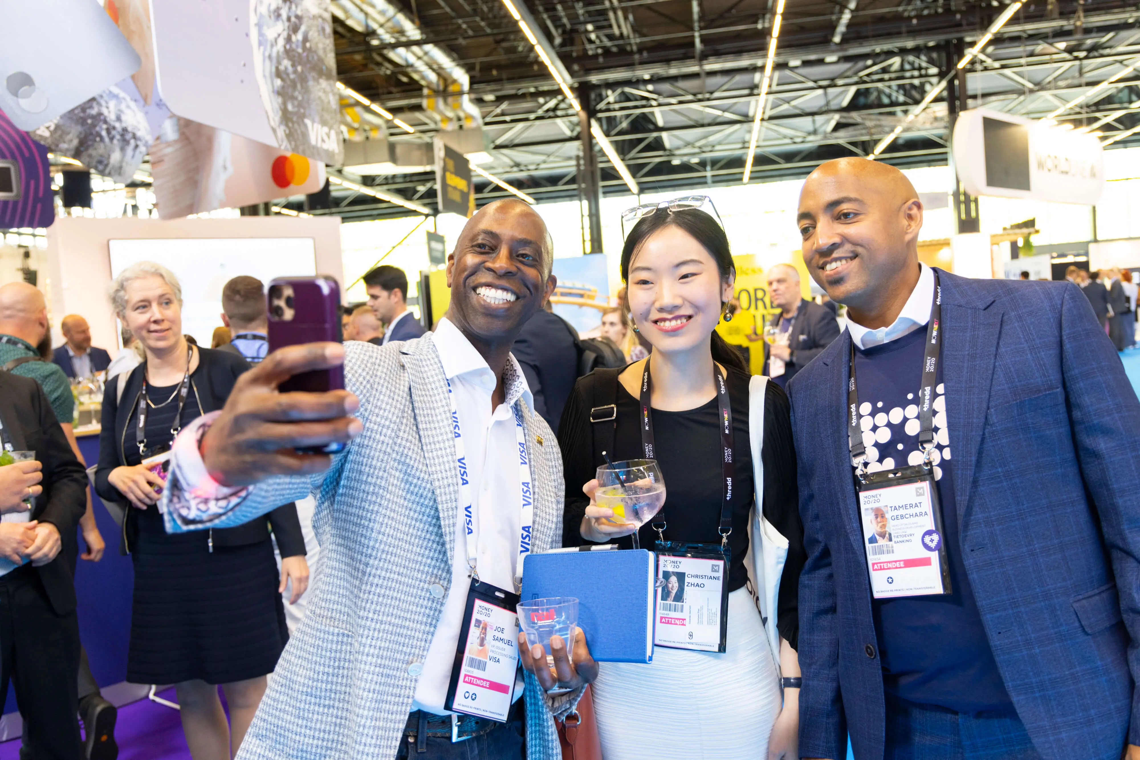 Two men and a woman take a selfie at Money20/20