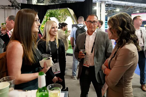 A group of four people attend a Money20/20 networking event.