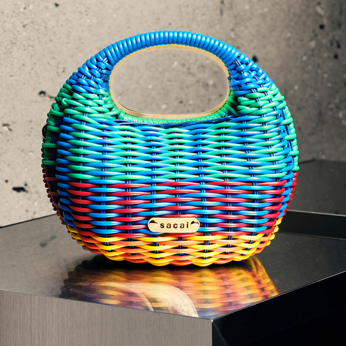 Sacai dresses their rattan bag with a splash of colour