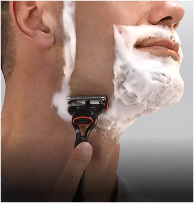 Face shaving category tile showing a man shaving his beard with a Gillette razor.