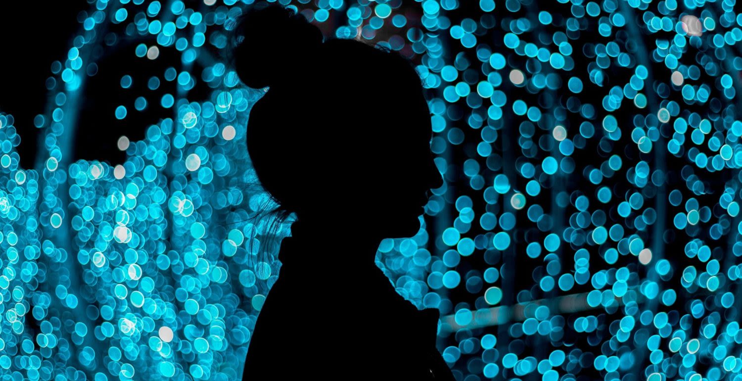 Woman silhouette blue light background