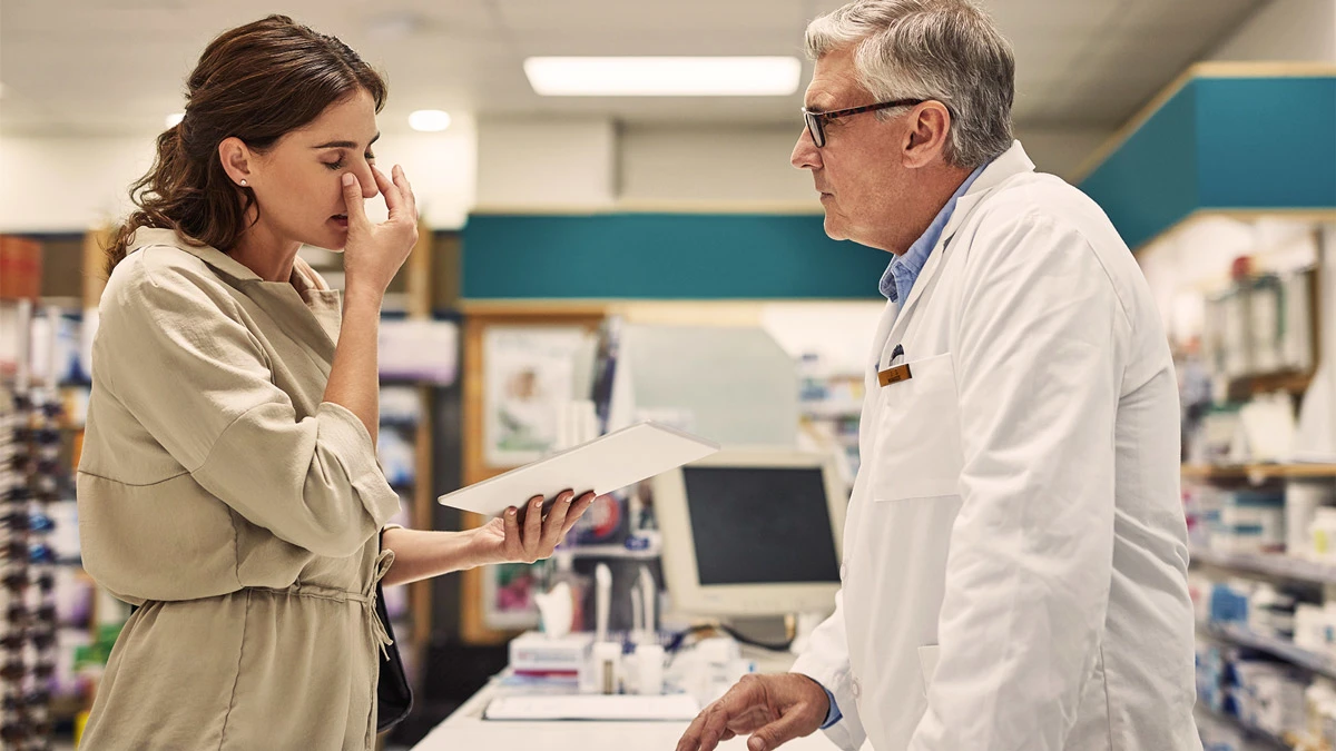 Woman discussing symptoms with doctor