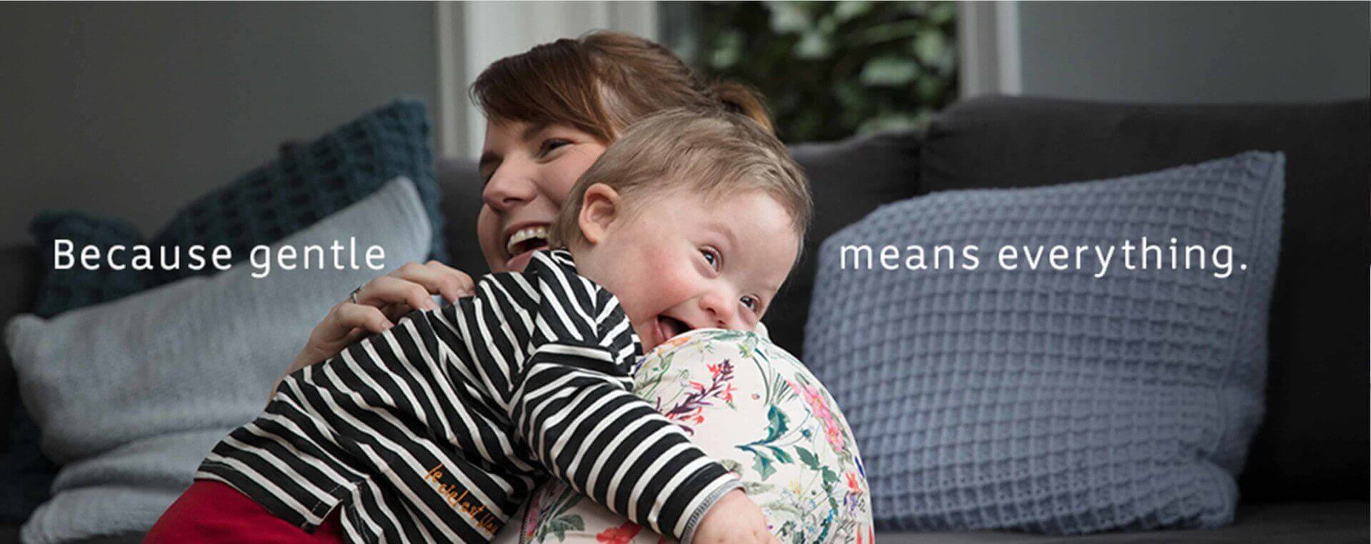 Baby and Mom hugging happily