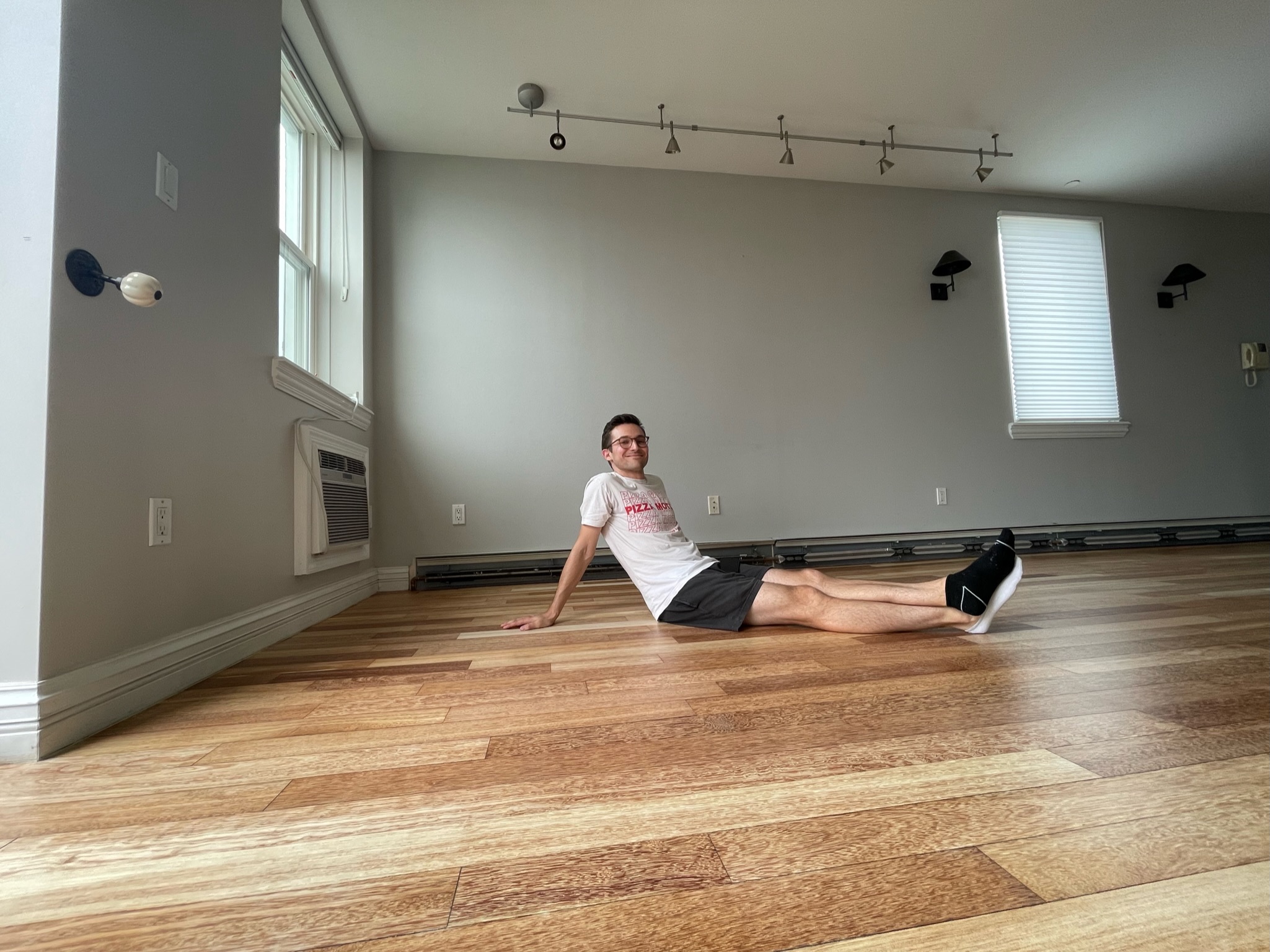 Me sitting on the refinished floor of our new home