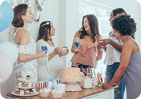 5 people talking at a baby shower