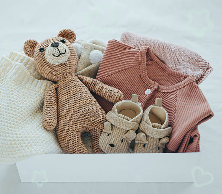 Baby shower gift ideas: a box with toys and baby clothes