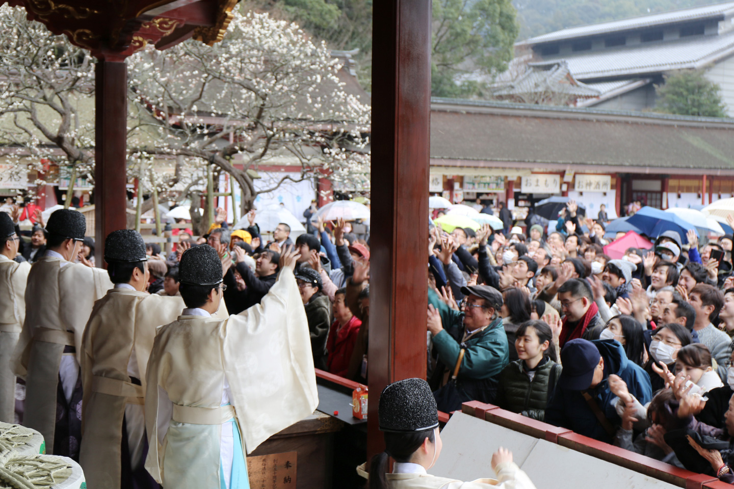 Visitors scramble to collect beans during a Setsubun festival at