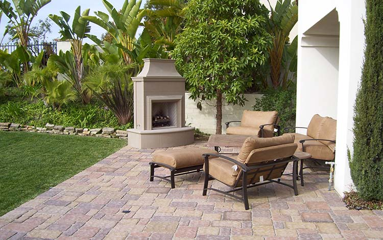 Outdoor fireplace, paver patio, patio furniture, outdoor living, backyard, fire, paving stones, California, daytime