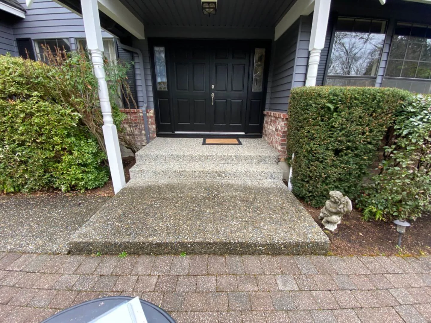 Dated pebble stone steps and entry before renovations
