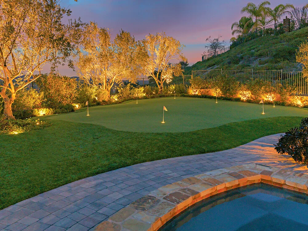 Paver patio, turf putting green, outdoor lighting