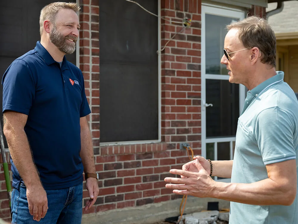 The host of Lifetime TV Military Makeover interviews System Pavers employee, Joe Kaufman