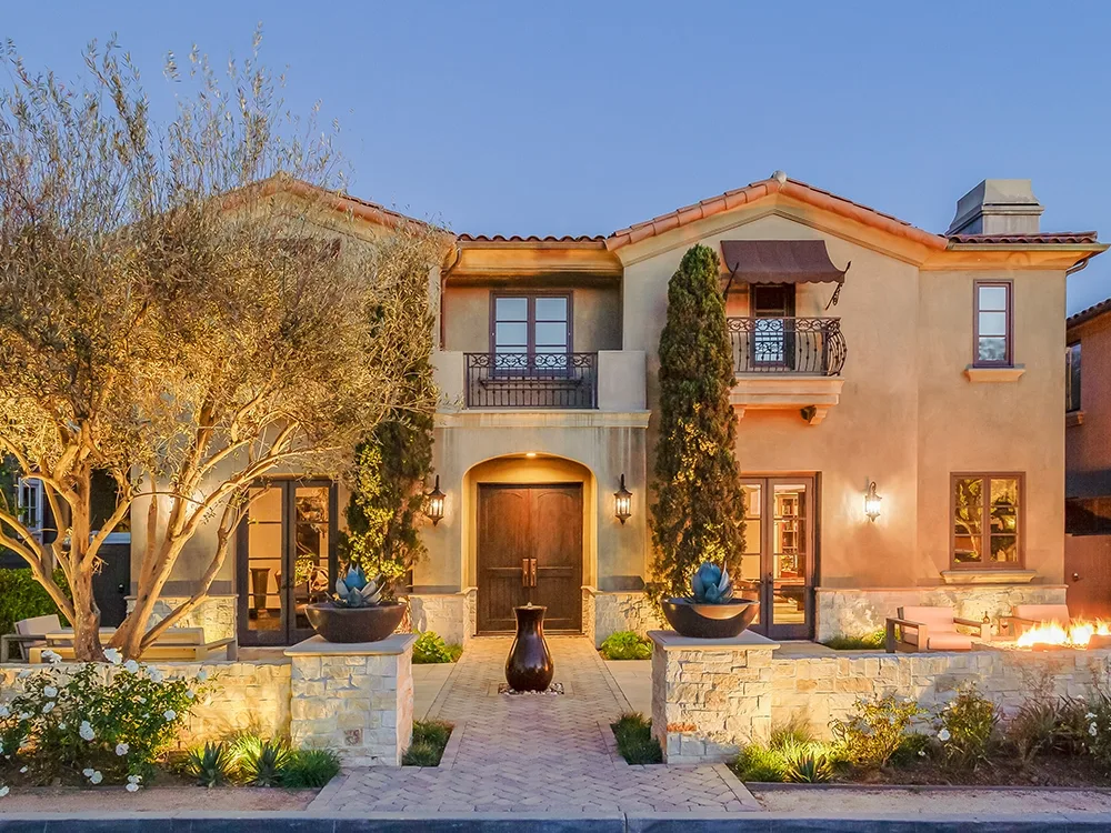 Incredible home in Texas with lighting, front paver patio, paving stone wall.