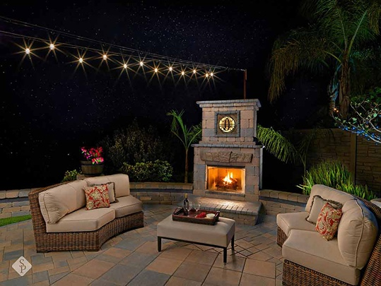 patio with fireplace at night